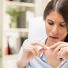 Woman Examining Pill