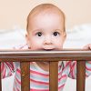 Baby Boy Chewing on Crib