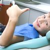 Kid Smiling in a Dental Chair