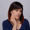 Young Woman with Jaw Pain